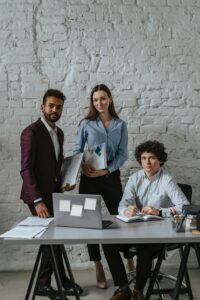 Three colleagues discussing plans in a modern office environment.